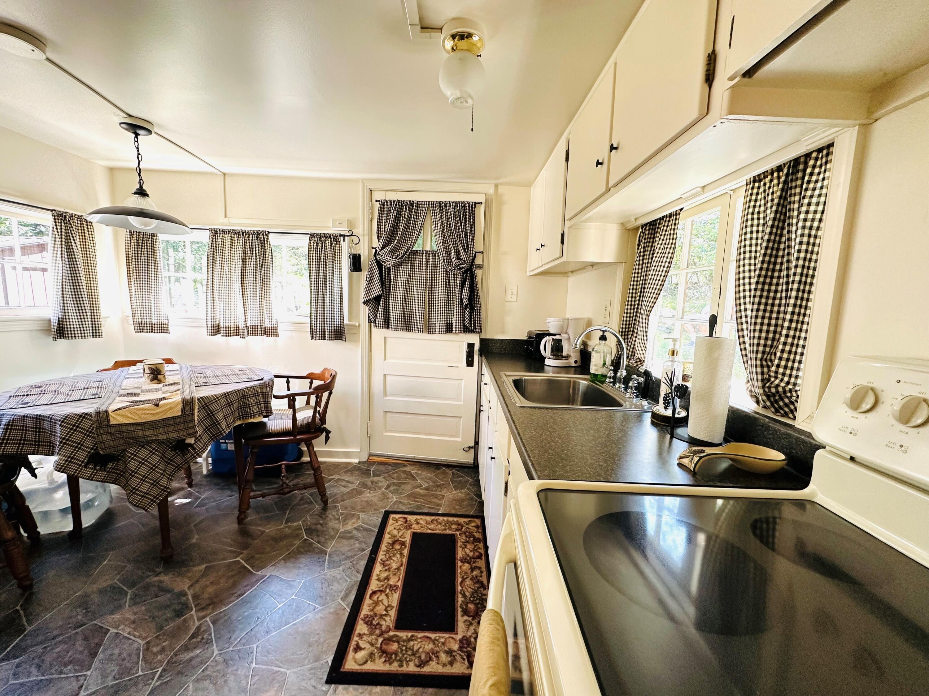 139 Pecks Pond Road Dingmans Ferry, PA 18328 - Photo 8 of 26 a kitchen with stainless steel appliances granite countertop a sink a stove and a refrigerator