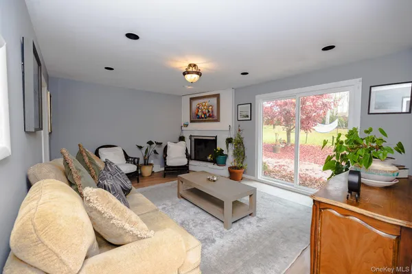 a living room with furniture a window and a flat screen tv