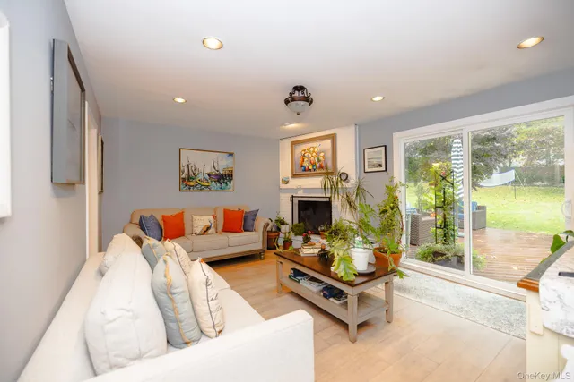 a living room with furniture fireplace and a large window