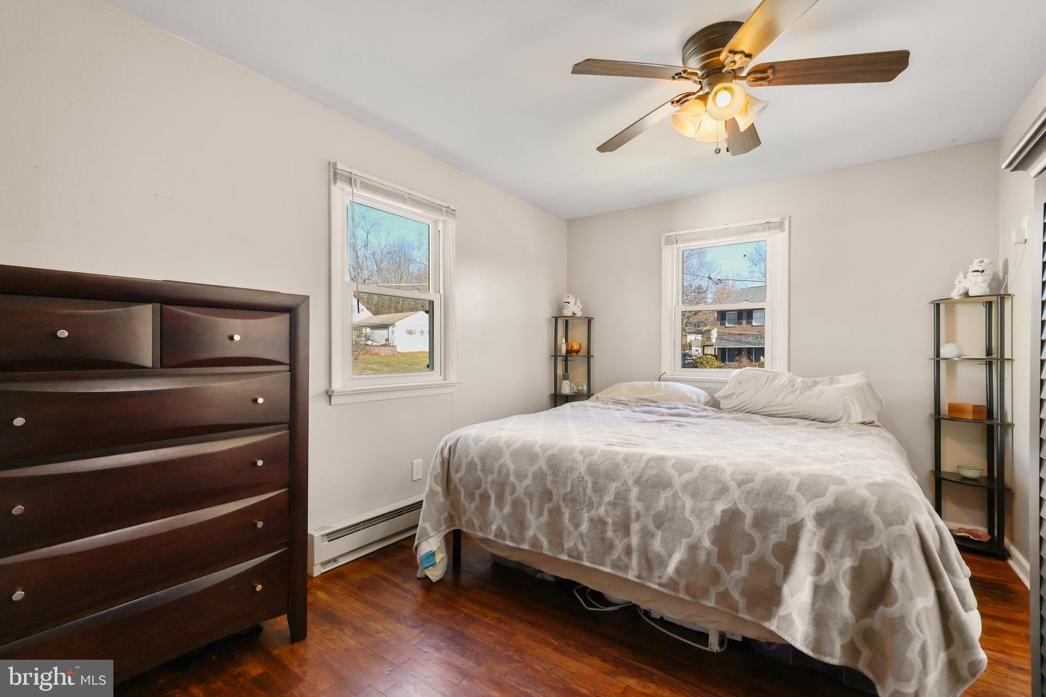 912 Arch Street Perkasie, PA 18944 - Photo 11 of 23 a bedroom with a bed a chandelier and a window