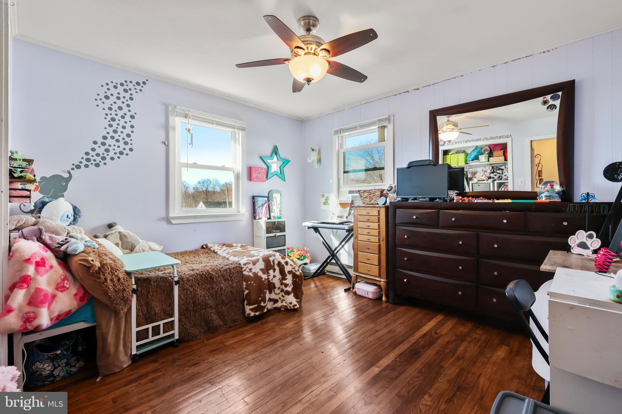 912 Arch Street Perkasie, PA 18944 - Photo 12 of 23 a bedroom with a bed and wooden floor