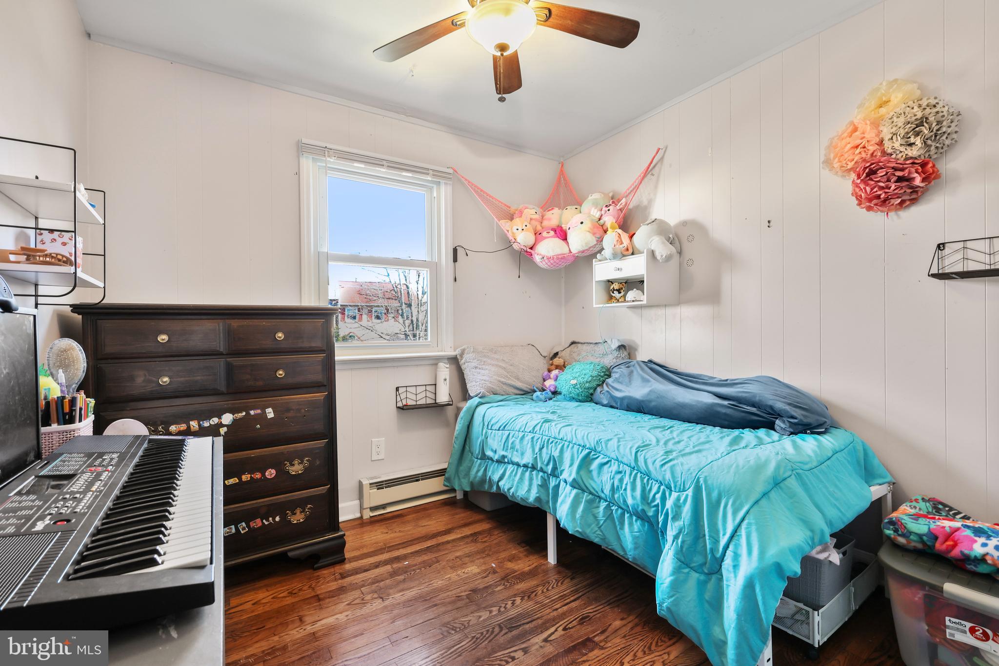 912 Arch Street Perkasie, PA 18944 - Photo 14 of 23 a bedroom with a bed and a chandelier