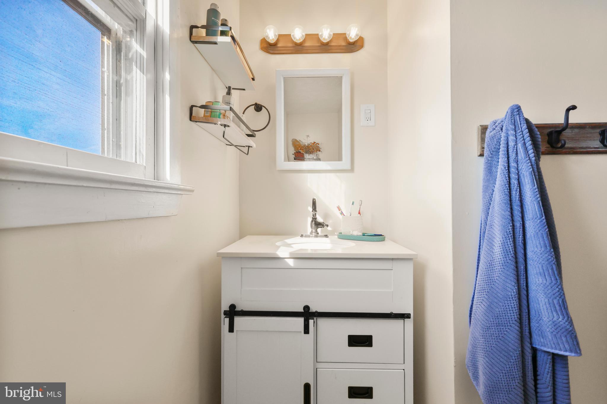 912 Arch Street Perkasie, PA 18944 - Photo 17 of 23 a bathroom with a sink and a mirror
