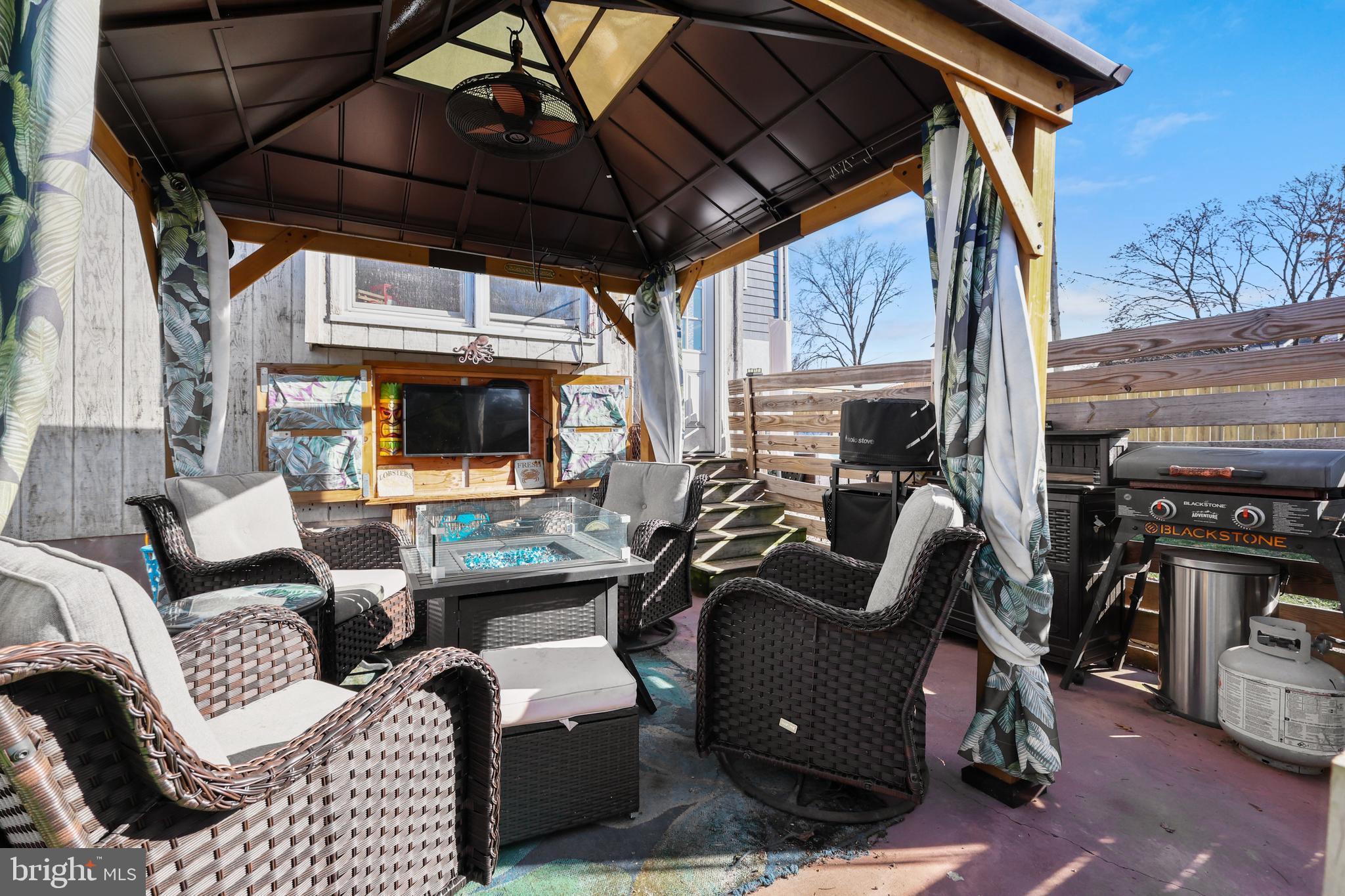 912 Arch Street Perkasie, PA 18944 - Photo 18 of 23 a view of a patio with couches chairs and a small yard