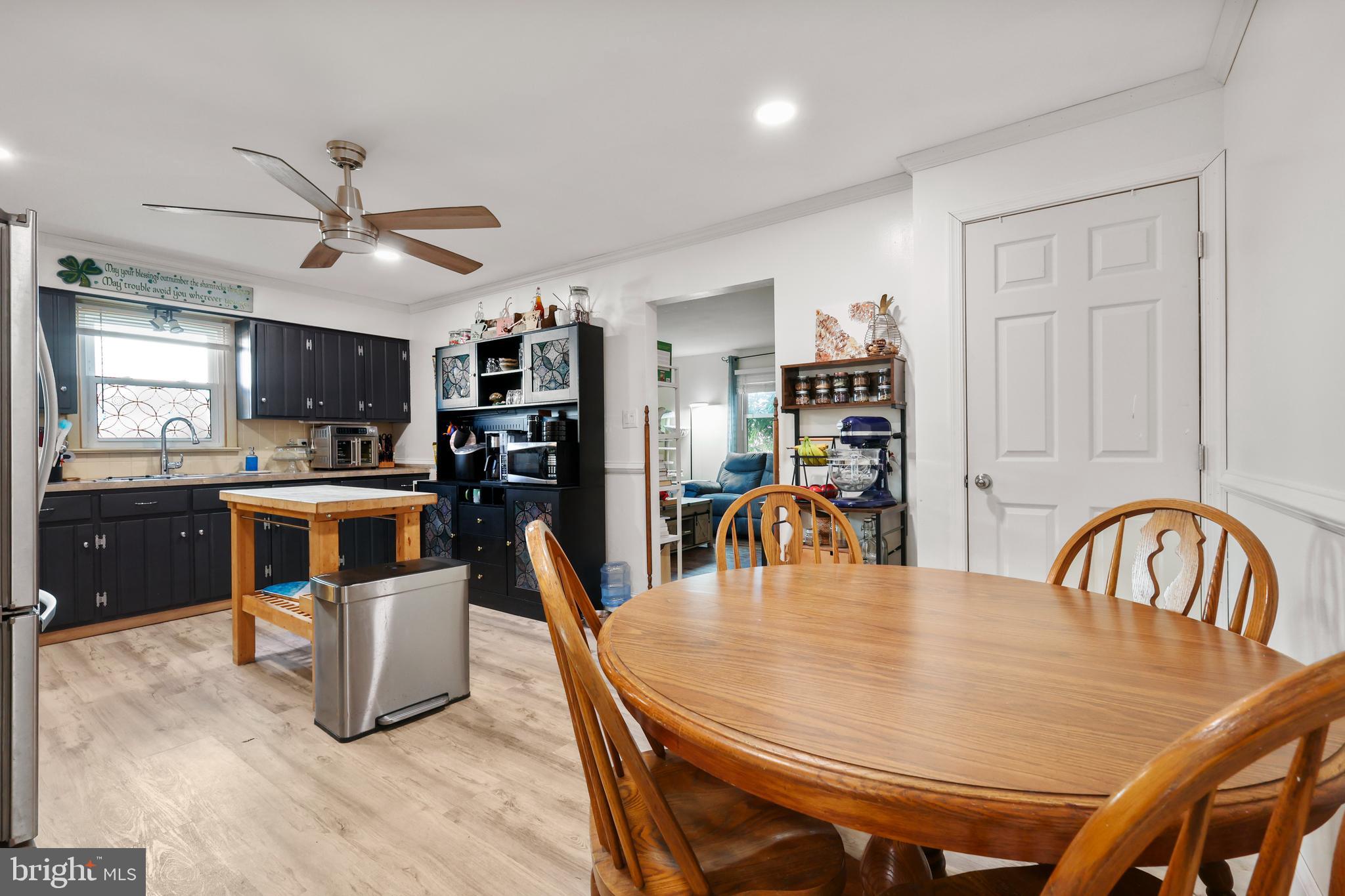 912 Arch Street Perkasie, PA 18944 - Photo 7 of 23 a kitchen with stainless steel appliances kitchen island granite countertop a dining table chairs and a refrigerator