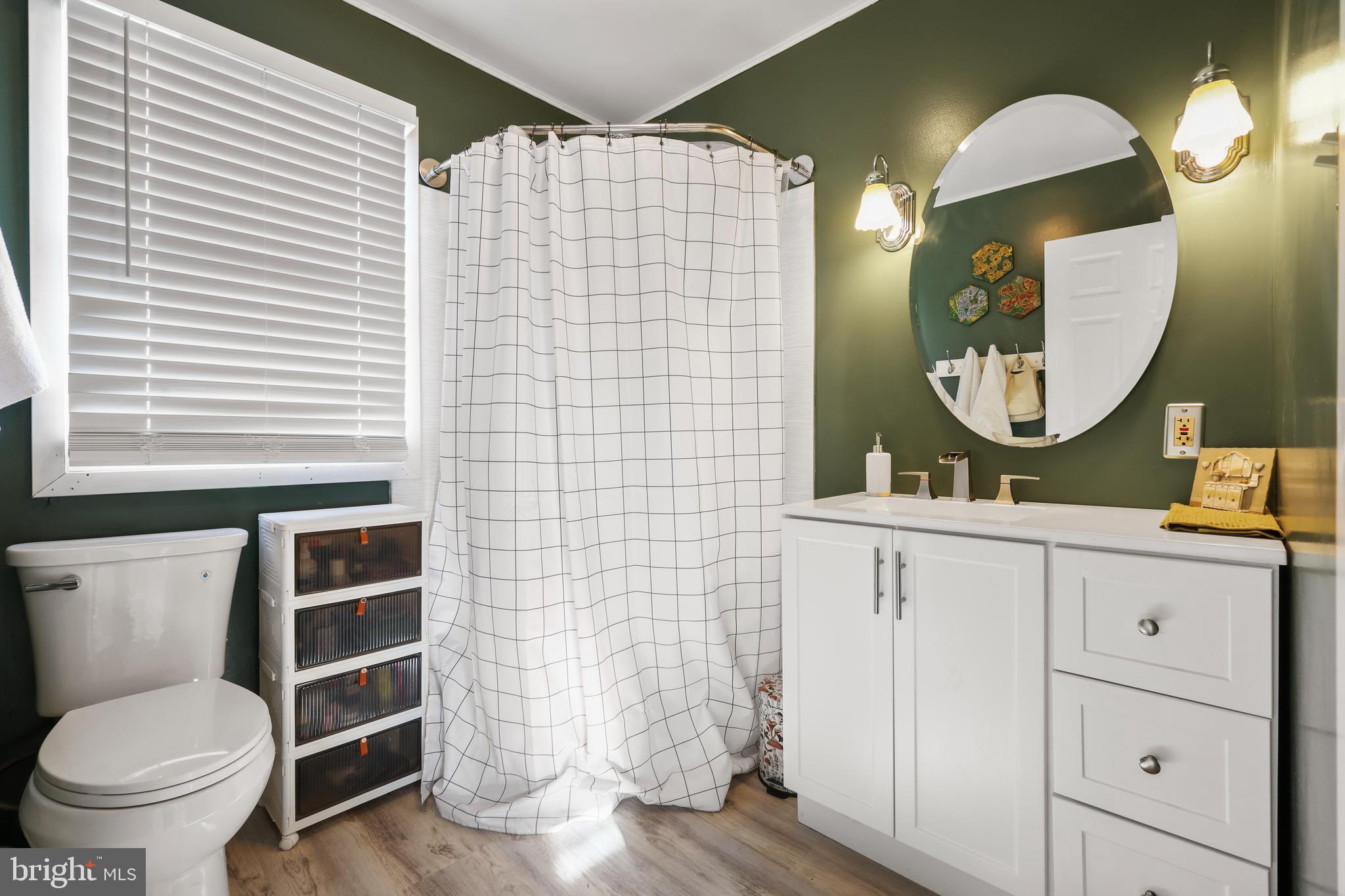 912 Arch Street Perkasie, PA 18944 - Photo 10 of 23 a bathroom with a toilet a sink and mirror