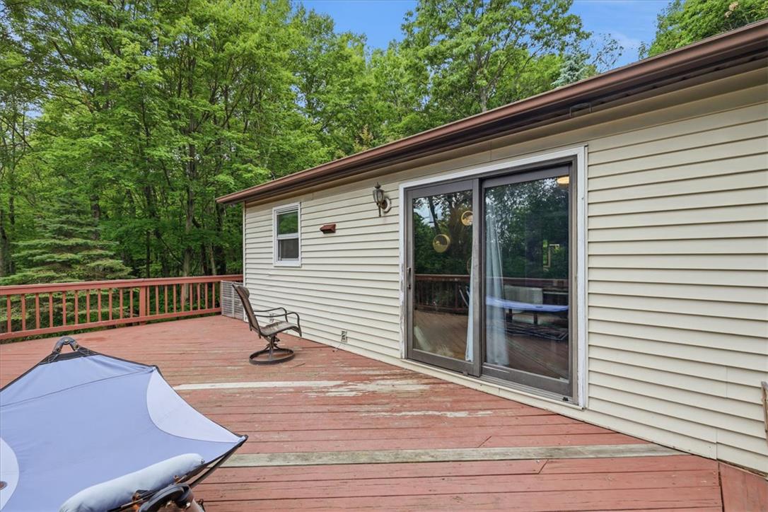 520 Highland Hill Road Jim Thorpe, PA 18235 - Photo 55 of 83 A spacious wooden deck provides ample outdoor living space, nestled among a verdant backdrop of mature trees.