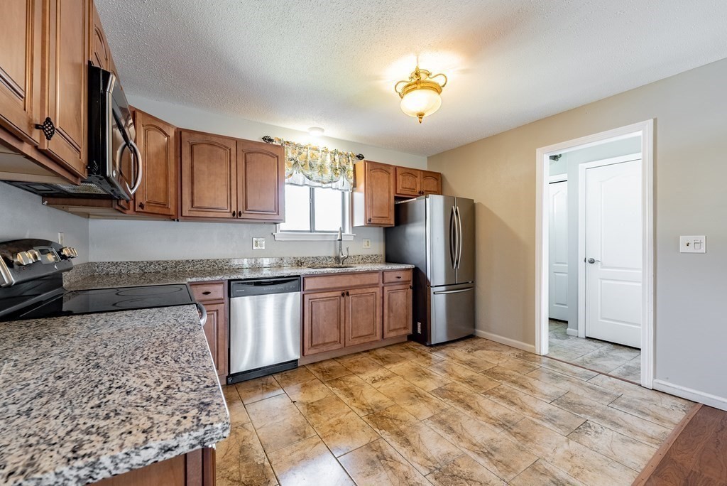 74 Beekman Drive, Unit 74 Agawam, MA 01001 - Photo 1 of 36 a kitchen with stainless steel appliances granite countertop a refrigerator sink and cabinets