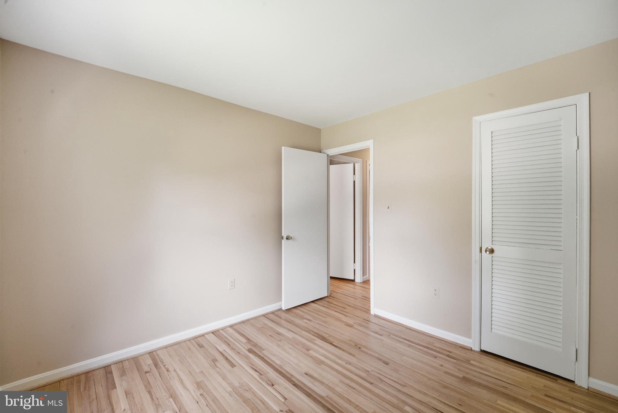 13309 Old Forge Road Silver Spring, MD 20904 - Photo 37 of 52 a view of an empty room with wooden floor and closet