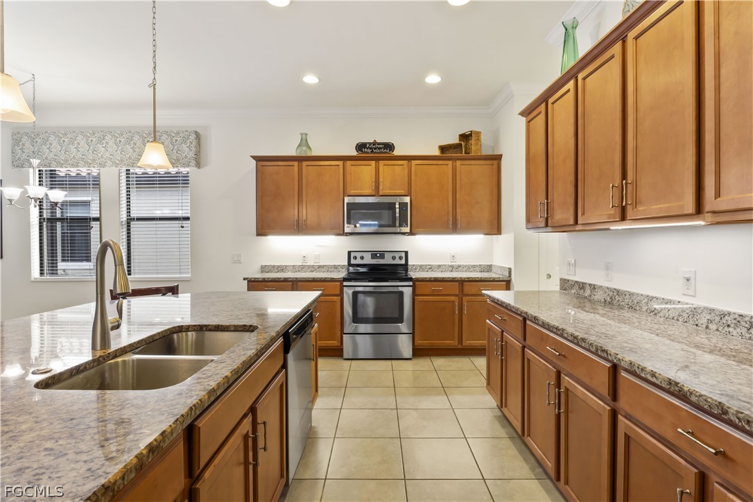 11767 Timbermarsh Court Fort Myers, FL 33913 - Photo 14 of 42 a kitchen with granite countertop a sink a counter top space appliances and cabinets