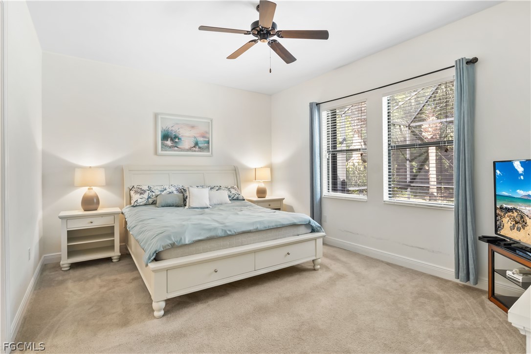 11767 Timbermarsh Court Fort Myers, FL 33913 - Photo 18 of 42 a spacious bedroom with a bed a dresser and next to a window