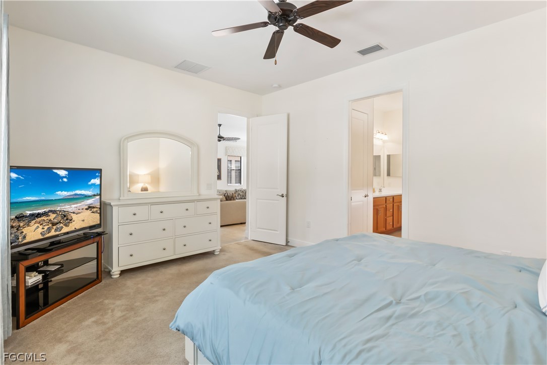 11767 Timbermarsh Court Fort Myers, FL 33913 - Photo 19 of 42 a bedroom with a bed and a dresser