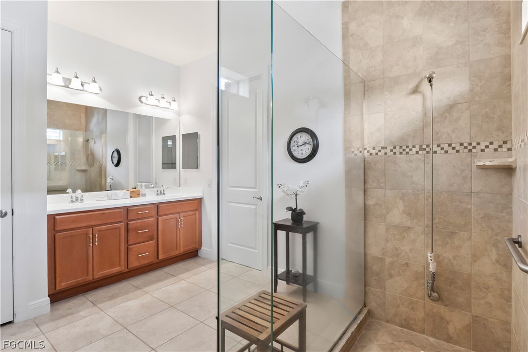 11767 Timbermarsh Court Fort Myers, FL 33913 - Photo 21 of 42 a spacious bathroom with a sink and a large mirror
