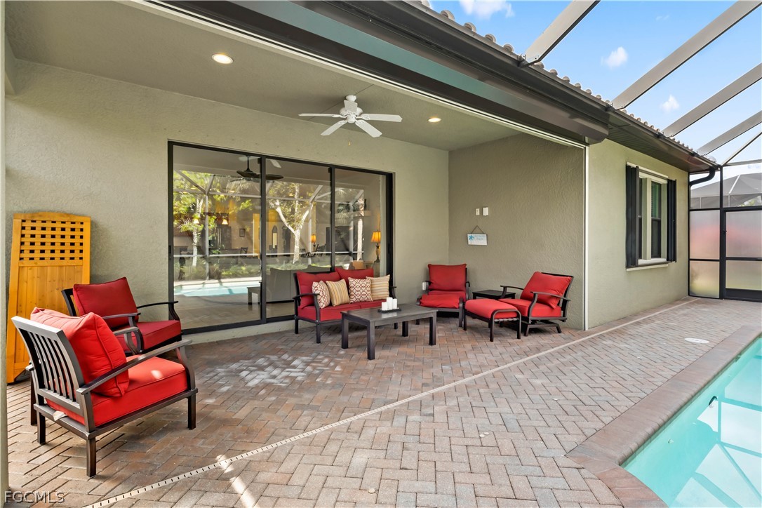 11767 Timbermarsh Court Fort Myers, FL 33913 - Photo 33 of 42 a living room with furniture and a floor to ceiling window
