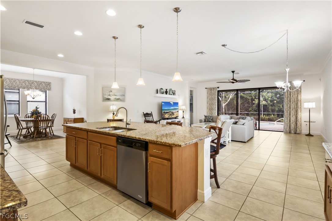 11767 Timbermarsh Court Fort Myers, FL 33913 - Photo 5 of 42 a large kitchen with kitchen island a large center island and a view of living room