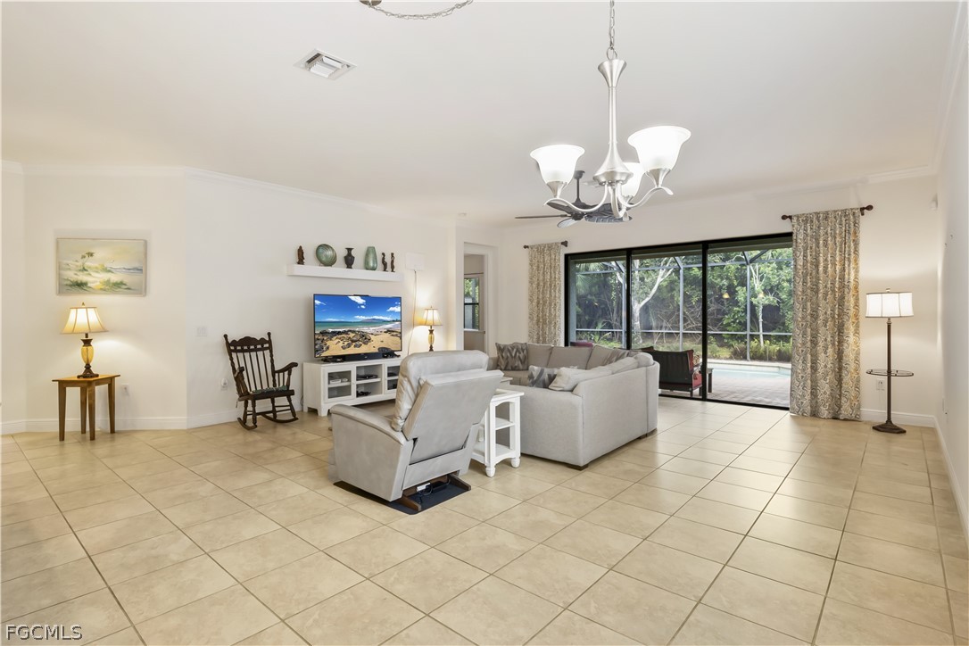 11767 Timbermarsh Court Fort Myers, FL 33913 - Photo 7 of 42 a living room with fireplace furniture and a chandelier