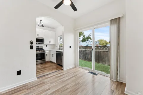 a view of a kitchen with wooden floor and a window