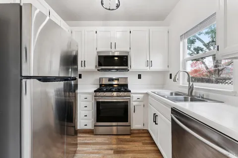 a kitchen with a sink stove and refrigerator