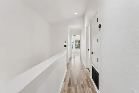 a view of a bathroom with sink and wooden floor