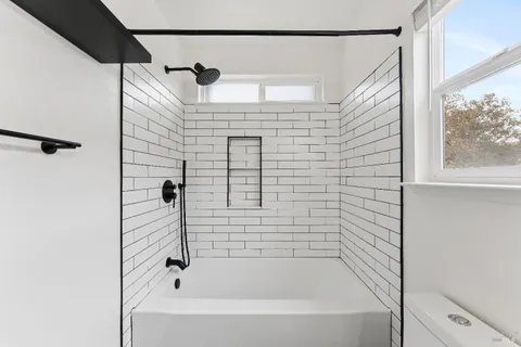 a bathroom with a shower and a bathtub