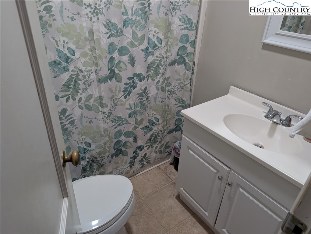 1616 Highway 194 Boone, NC 28607 - Photo 8 of 12 a bathroom with a sink and a mirror