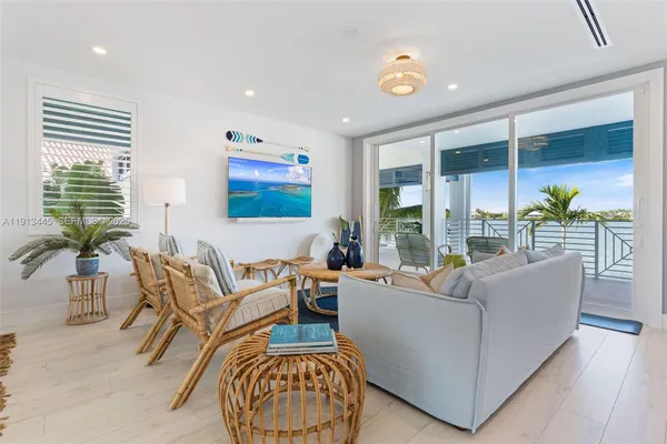 a kitchen with stainless steel appliances kitchen island granite countertop a refrigerator and cabinets