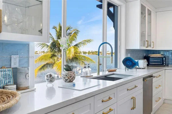 a large kitchen with a table and chairs