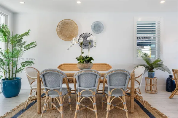 a living room with furniture a flat screen tv and floor to ceiling window