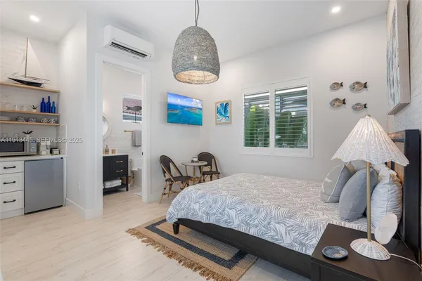 a bedroom with a bed and a chandelier