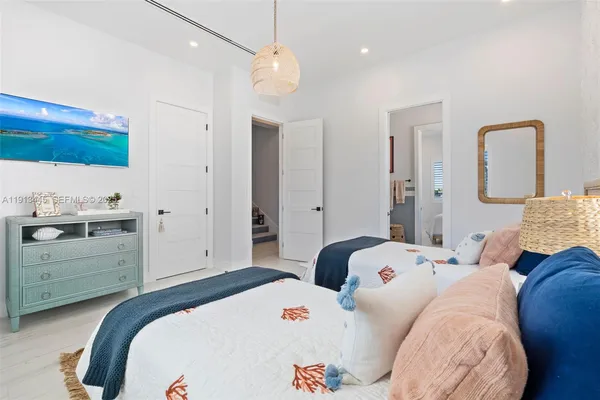 a bedroom with a bed and glass windows