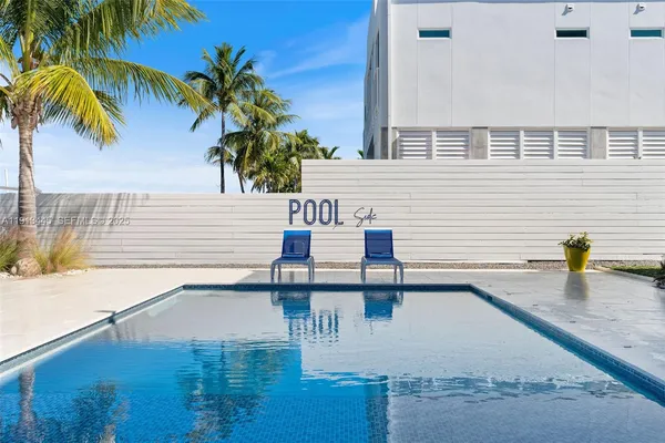 a view of a palm trees front of house with a yard
