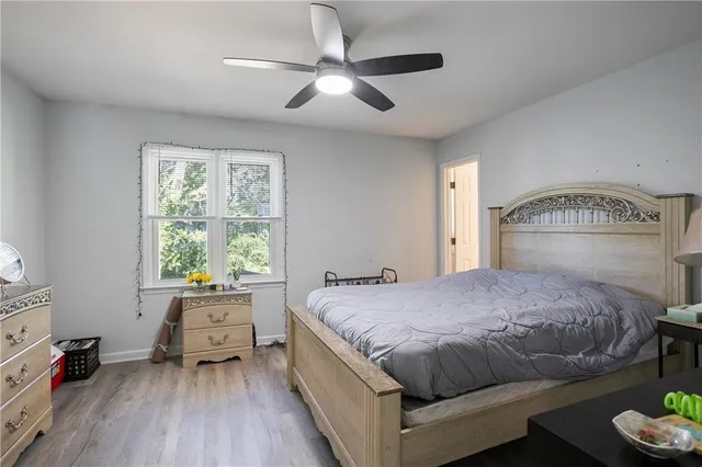 a bedroom with a bed and a large window