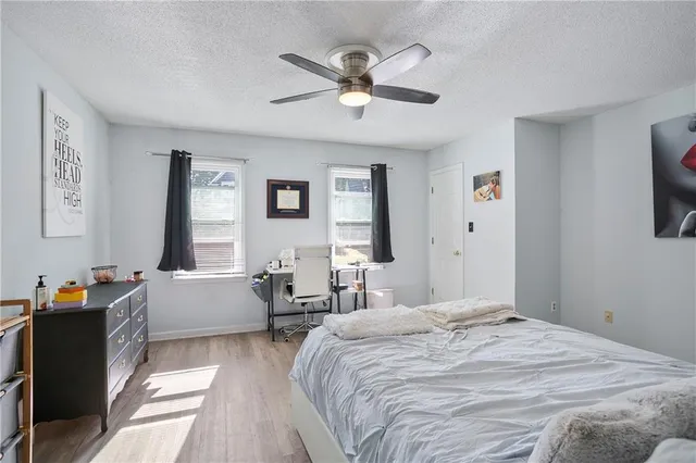 a bedroom with a bed and a large window