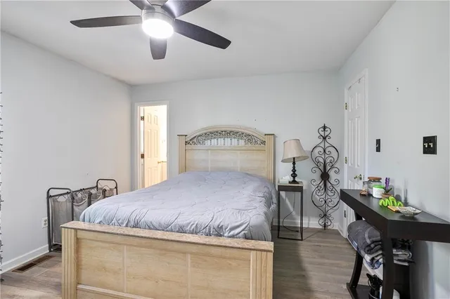 a bedroom with a bed and a large window