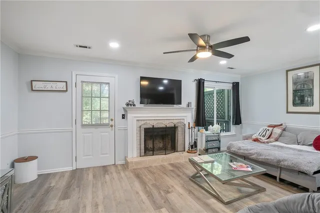 a living room with furniture a fireplace and a flat screen tv