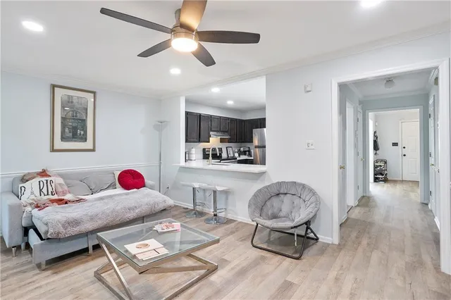 a living room with furniture and a wooden floor