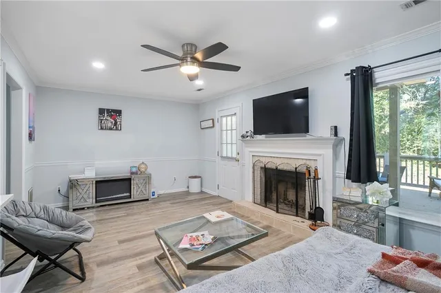 a living room with furniture a flat screen tv and a fireplace