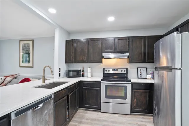 a kitchen with a sink stove and refrigerator