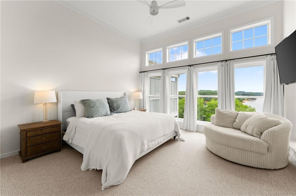 2300 Habersham Marina Road, Unit 302 Cumming, GA 30041 - Photo 16 of 31 a spacious bedroom with a bed and glass window