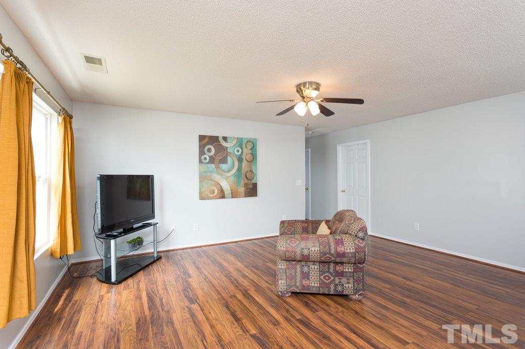 3169 Varcroft Road Knightdale, NC 27545 - Photo 4 of 9 a living room with furniture and a flat screen tv