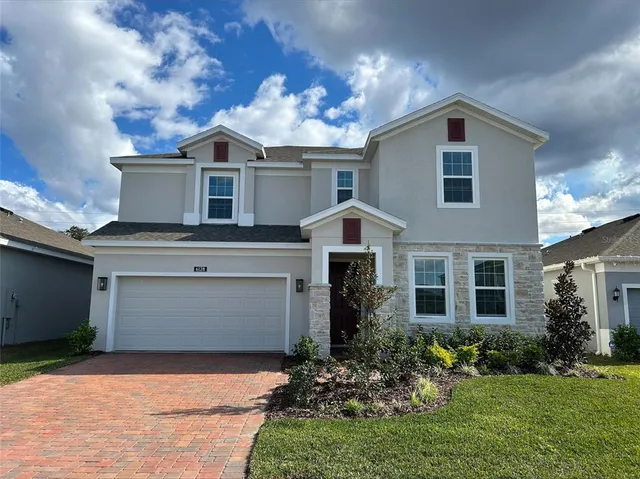 a front view of a house with a yard and garage