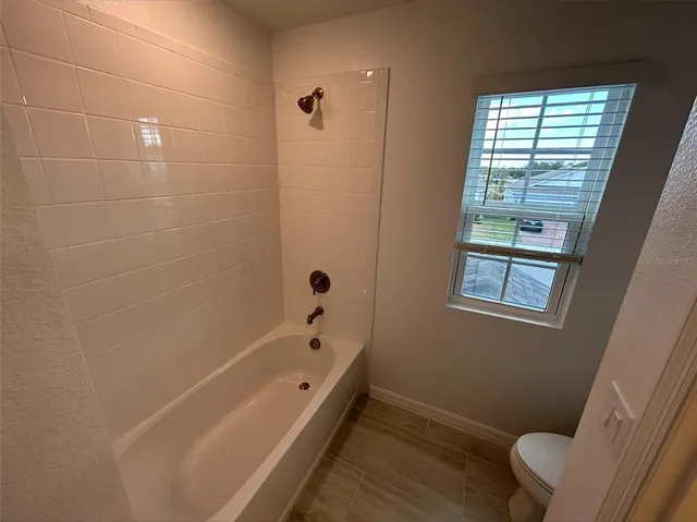 a bathroom with a bathtub and window