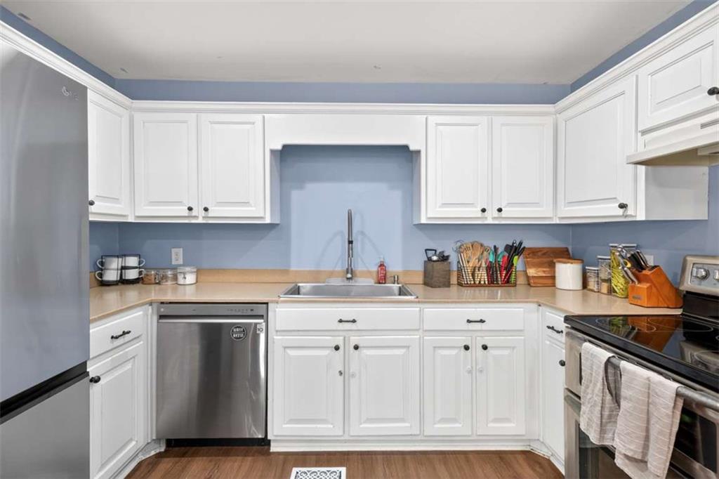386 Ridgewood Drive Pendergrass, GA 30567 - Photo 18 of 50 a kitchen with white cabinets and white appliances