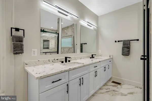 a bathroom with a double vanity sink and mirror