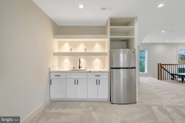a kitchen with refrigerator and window