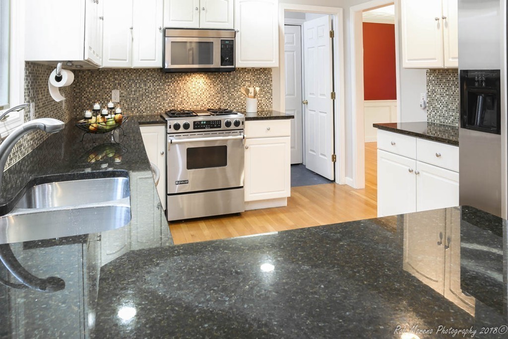 295 South Main Street Andover, MA 01810 - Photo 11 of 30 a kitchen with granite countertop a stove and a sink