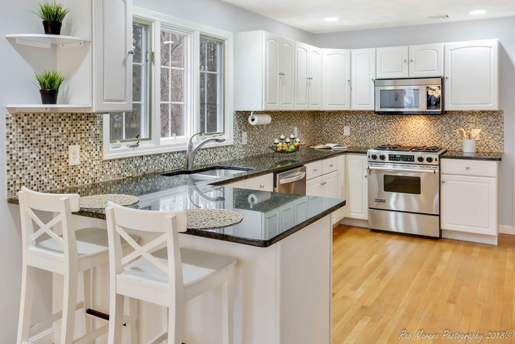 295 South Main Street Andover, MA 01810 - Photo 12 of 30 a kitchen with stainless steel appliances granite countertop a stove a sink and a microwave