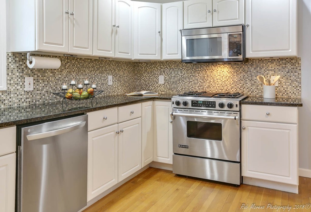 295 South Main Street Andover, MA 01810 - Photo 14 of 30 a kitchen with granite countertop white cabinets stainless steel appliances and wooden floor