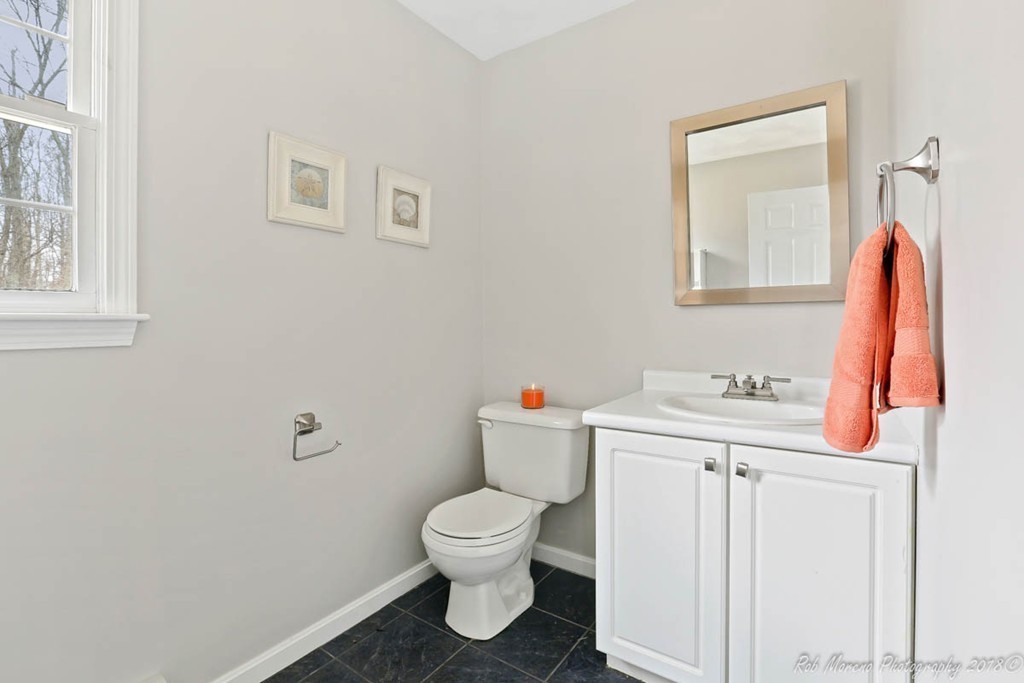 295 South Main Street Andover, MA 01810 - Photo 18 of 30 a white toilet sitting next to a bathroom sink