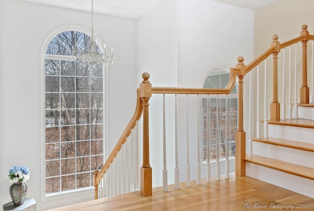 295 South Main Street Andover, MA 01810 - Photo 19 of 30 a view of staircase with white walls and a window